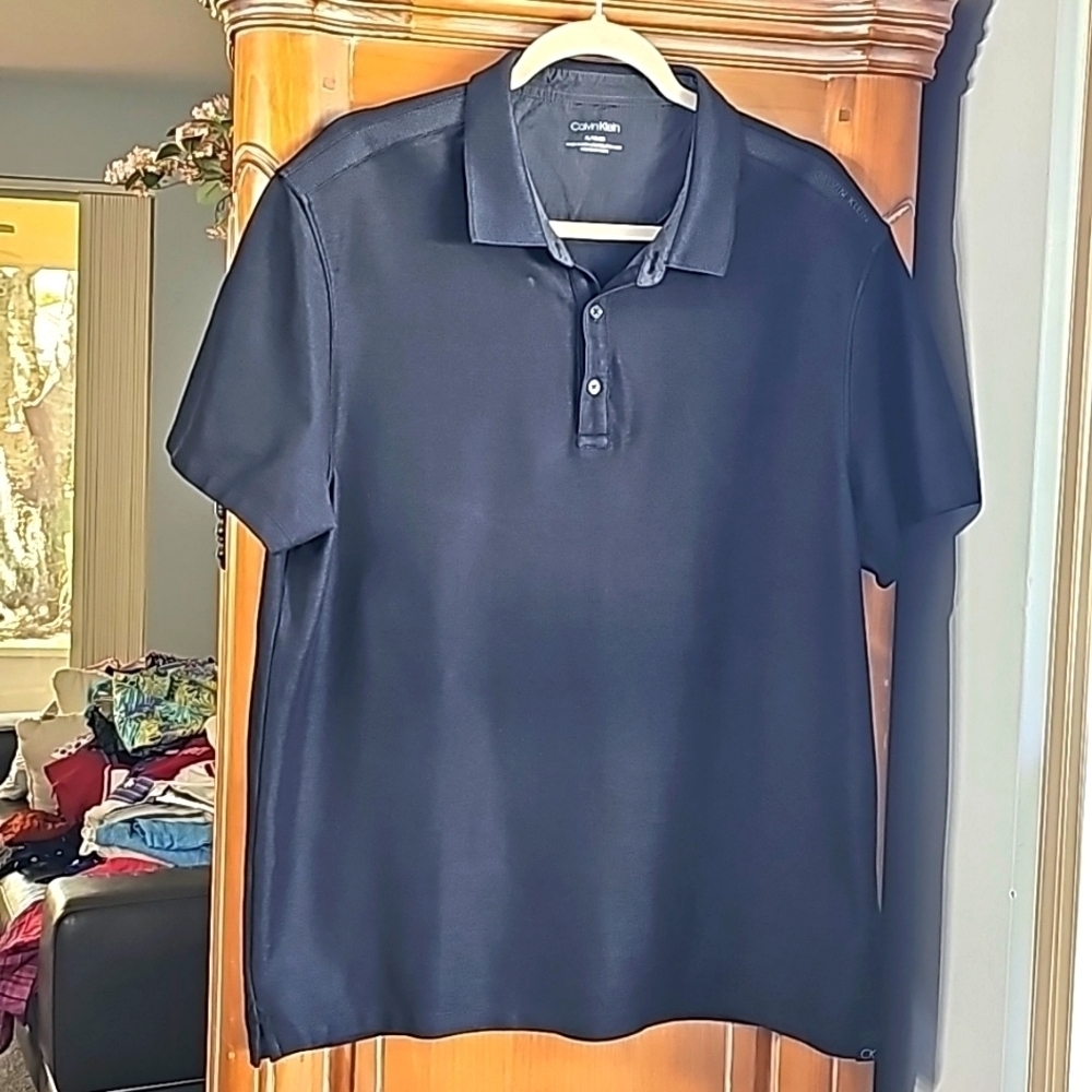 Mens black pole shirt by Calvin Klein. XL. Great golf‎ shirt with short sleeves.